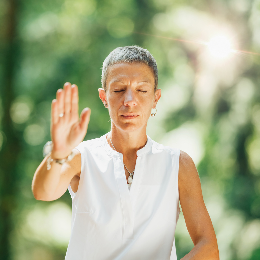 Qi Gong Female Expert Doing Qigong Exercises Outdoor for Moving "Chi" or Energy in the Body